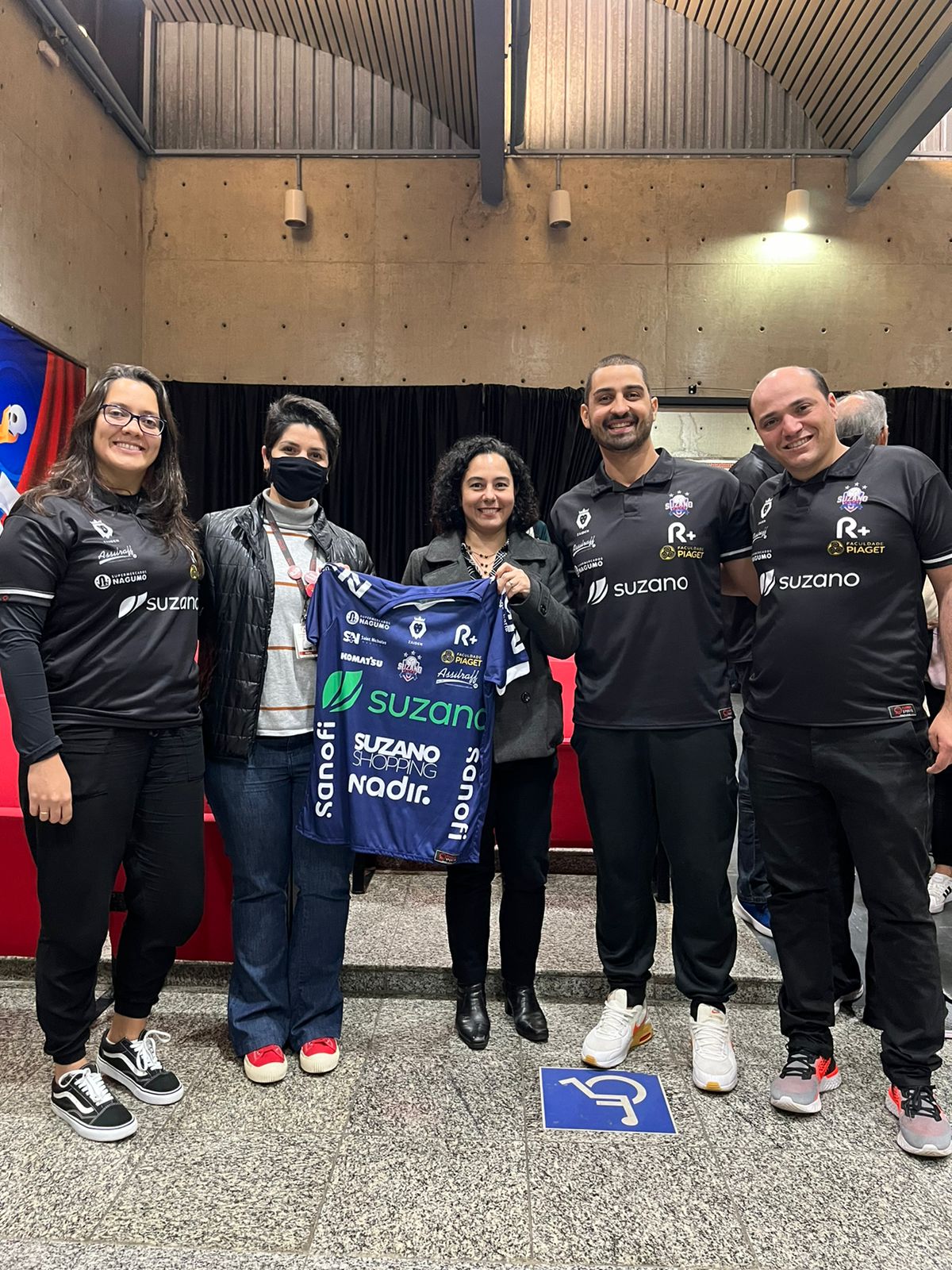 Coordenadora do Curso de Fisioterapia Profa. Maíra Campos, Diretora Acadêmica Profa. Poliana Lima com a equipe de fisioterapeutas do Suzano Vôlei exibindo a nova camisa do time